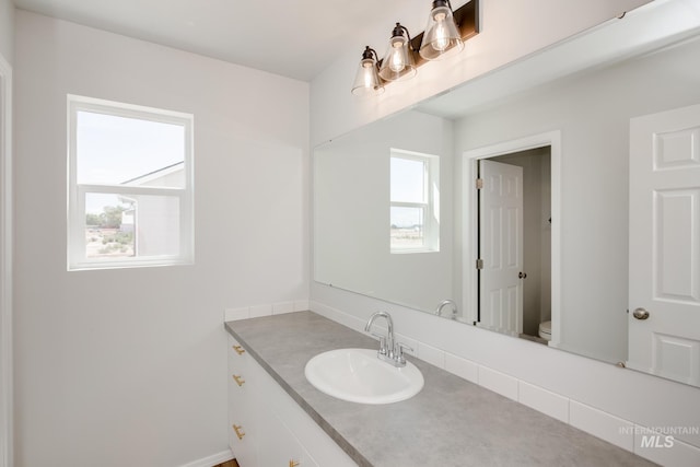bathroom with vanity and toilet