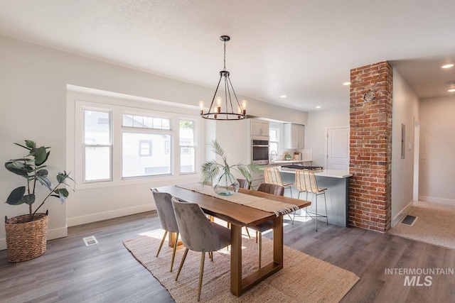 dining area with dark wood-style flooring, recessed lighting, visible vents, and baseboards