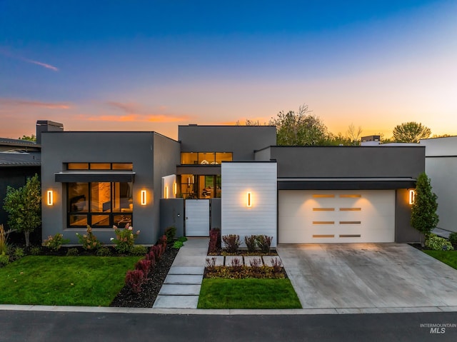 contemporary home featuring a yard and a garage