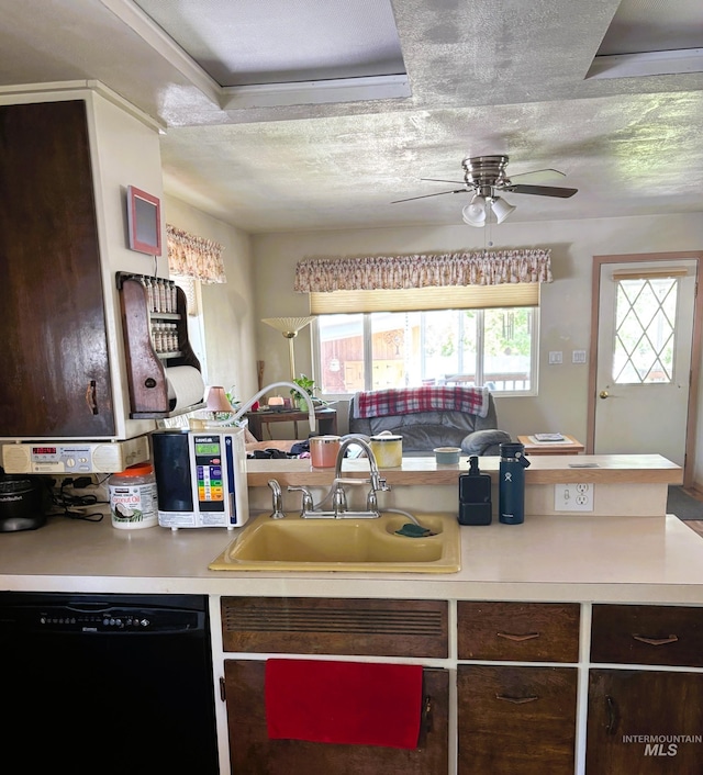 kitchen with dishwasher, a sink, a ceiling fan, dark brown cabinetry, and light countertops