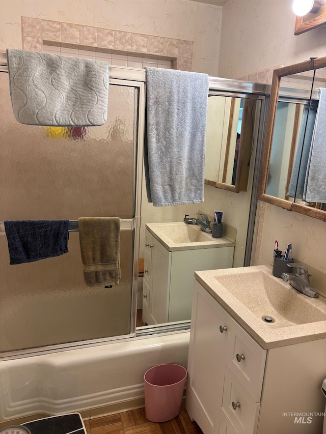 full bathroom featuring combined bath / shower with glass door and vanity