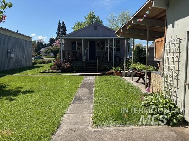 bungalow-style house with a front lawn and a porch