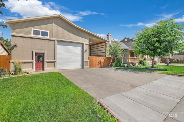 view of front of home with a garage and a front lawn