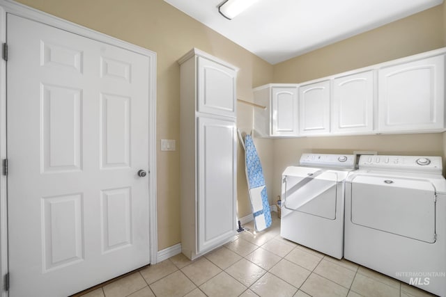 3408 Ridgeline Dr, Kimberly, ID 83341 - laundry area featuring light tile patterned flooring, cabinet space, baseboards, and washer and clothes dryer
