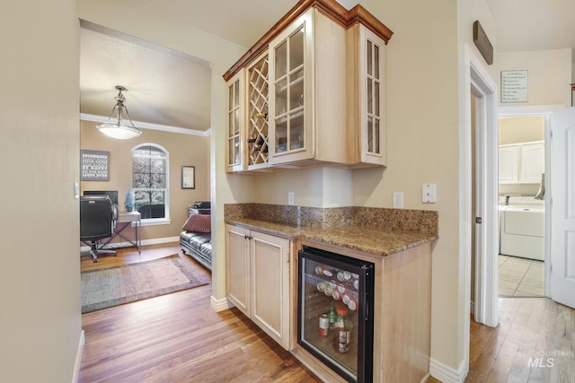 3408 Ridgeline Dr, Kimberly, ID 83341 - kitchen featuring wine cooler, light stone counters, light wood finished floors, washing machine and dryer, and glass insert cabinets