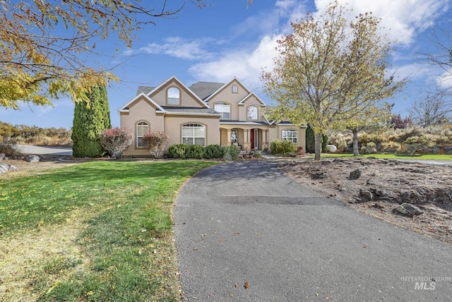 3408 Ridgeline Dr, Kimberly, ID 83341 - traditional-style home featuring a front yard, stucco siding, and aphalt driveway