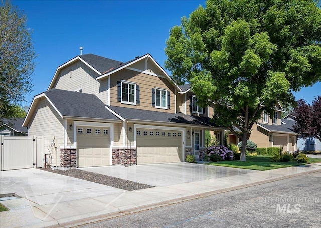 4226 E Tahiti St, Meridian, ID 83646 - craftsman inspired home featuring driveway, a gate, stone siding, fence, and a garage