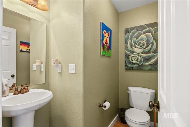 4226 E Tahiti St, Meridian, ID 83646 - bathroom featuring toilet, a sink, wood finished floors, and a textured wall