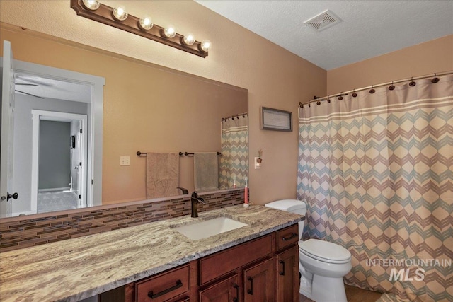 4226 E Tahiti St, Meridian, ID 83646 - bathroom with vanity, toilet, a textured ceiling, and curtained shower