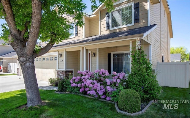 4226 E Tahiti St, Meridian, ID 83646 - view of front facade with a garage, driveway, and covered porch