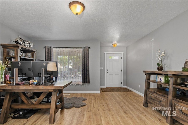 4226 E Tahiti St, Meridian, ID 83646 - home office featuring wood finished floors, a textured ceiling, and baseboards
