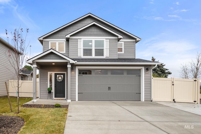 craftsman house featuring a front yard and a garage