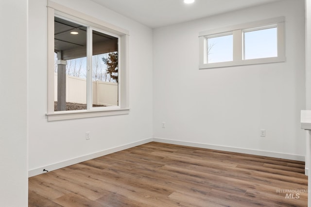 empty room featuring hardwood / wood-style flooring and a healthy amount of sunlight