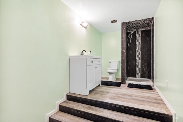 stairway featuring hardwood / wood-style floors and sink