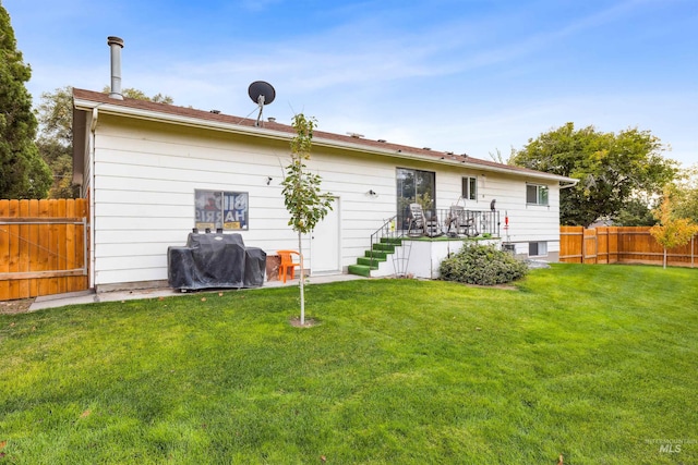 rear view of house with a yard