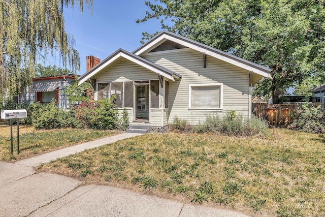 538 N 6th St, Payette, ID 83661 - view of front facade featuring a chimney and a sunroom