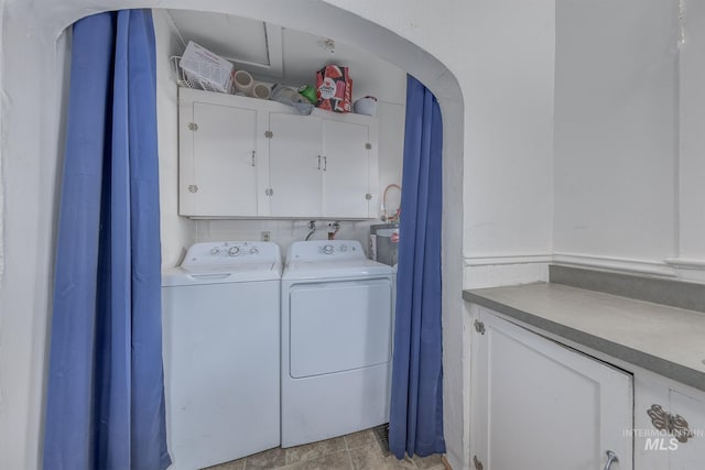 538 N 6th St, Payette, ID 83661 - laundry room featuring washer and clothes dryer, cabinet space, and arched walkways
