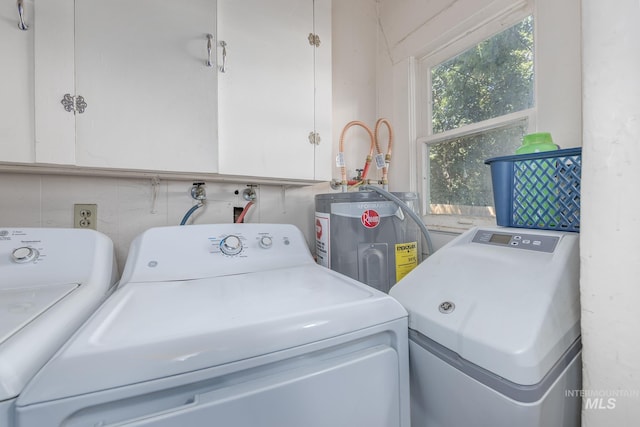 538 N 6th St, Payette, ID 83661 - washroom featuring washer and clothes dryer, cabinet space, and electric water heater