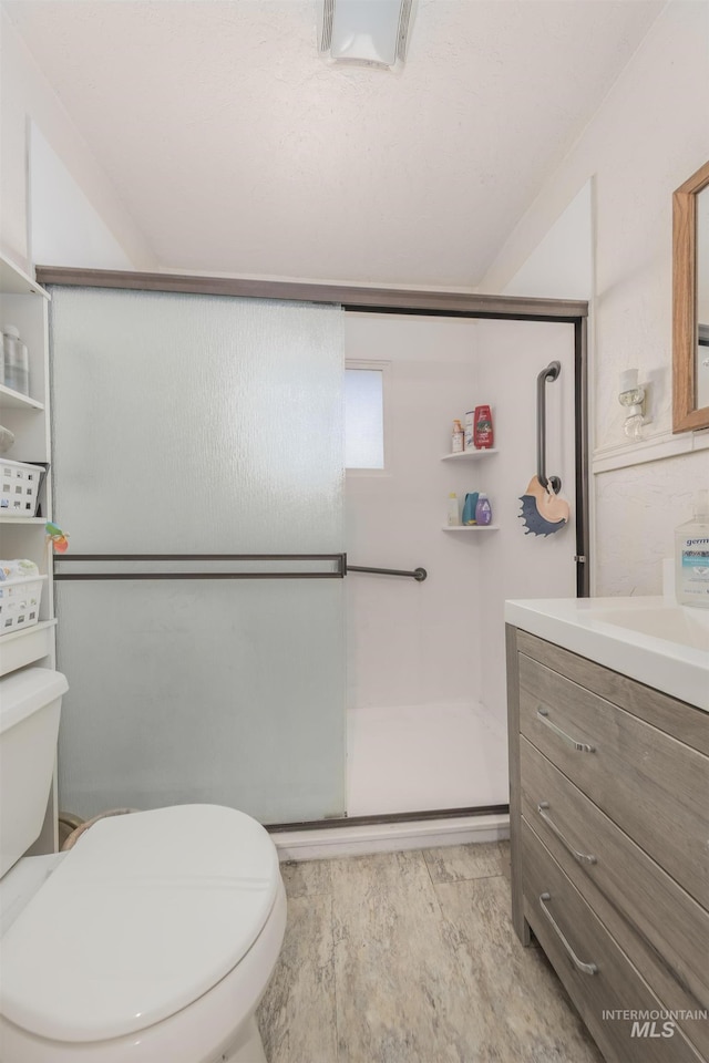 538 N 6th St, Payette, ID 83661 - full bath with a stall shower, vanity, and wood finished floors