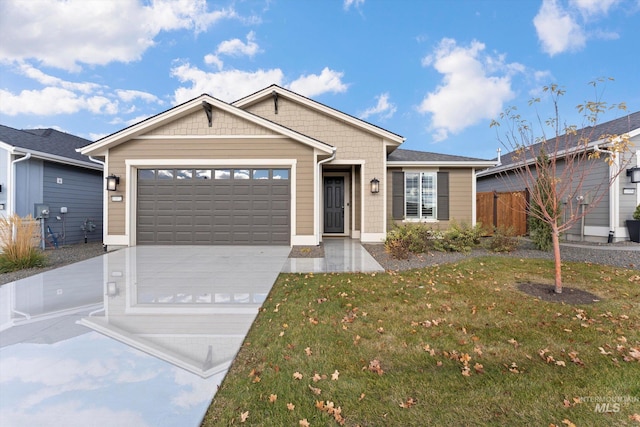 view of front of house featuring a front lawn and a garage