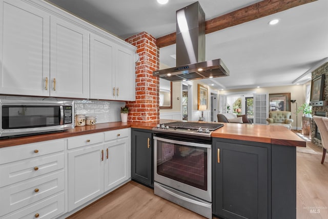 1924 Cleveland Blvd, Caldwell, ID 83605 - kitchen with appliances with stainless steel finishes, island range hood, wood counters, light wood finished floors, and beamed ceiling