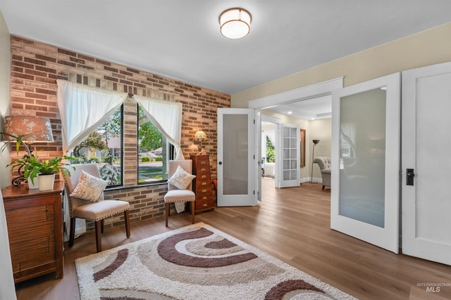 1924 Cleveland Blvd, Caldwell, ID 83605 - living area with french doors, wood finished floors, and brick wall