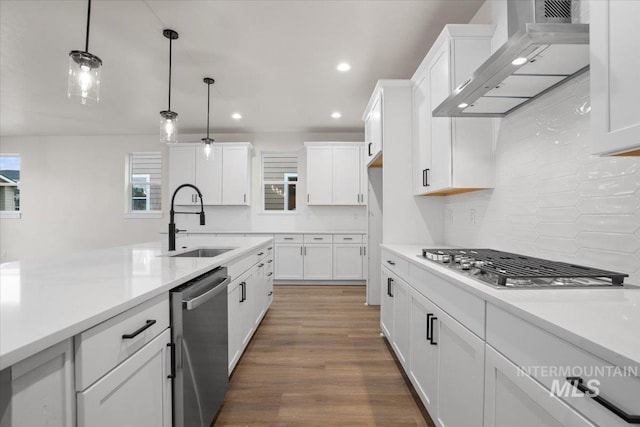 5801 W Escalante, Eagle, ID 83616 - kitchen featuring white cabinets, wall chimney exhaust hood, a sink, light countertops, and appliances with stainless steel finishes