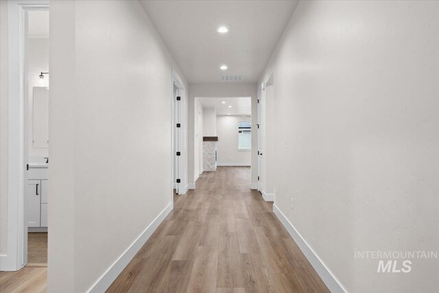 5801 W Escalante, Eagle, ID 83616 - hallway with light wood-style floors, baseboards, visible vents, and recessed lighting