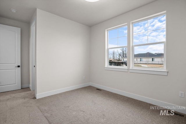 5801 W Escalante, Eagle, ID 83616 - spare room featuring carpet floors, baseboards, and visible vents