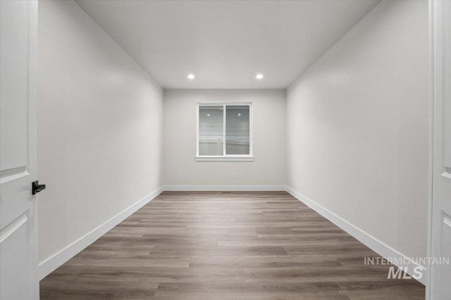 5801 W Escalante, Eagle, ID 83616 - spare room with wood finished floors, baseboards, and recessed lighting