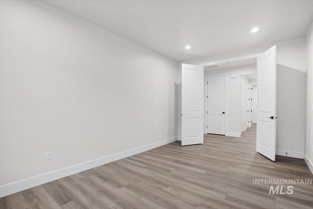 5801 W Escalante, Eagle, ID 83616 - unfurnished bedroom with light wood-style floors, baseboards, and recessed lighting