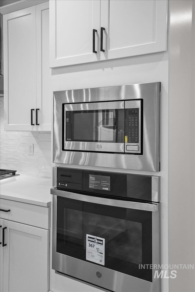 5801 W Escalante, Eagle, ID 83616 - room details featuring stainless steel appliances, light countertops, white cabinetry, and backsplash