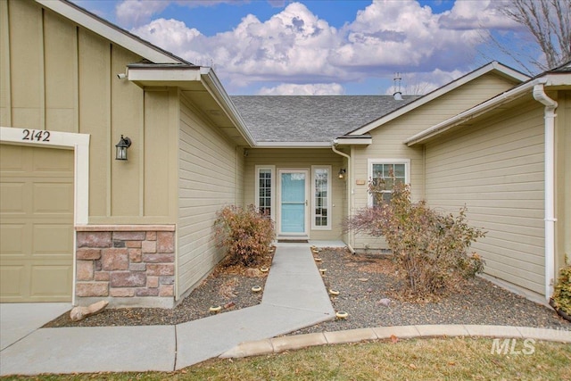 doorway to property with a garage