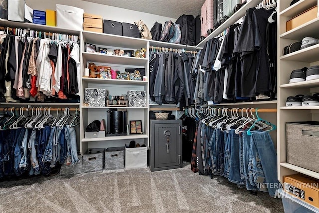 walk in closet with carpet floors