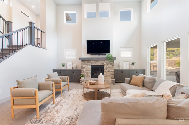 2649 E Mardia St, Meridian, ID 83642 - living area featuring a high ceiling, plenty of natural light, stairway, and a stone fireplace