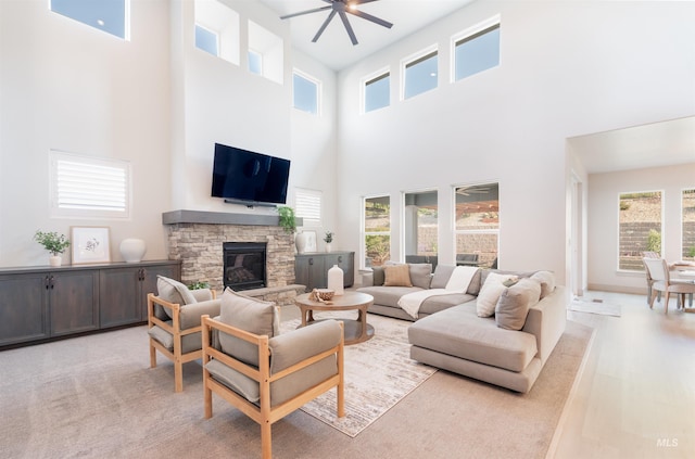 2649 E Mardia St, Meridian, ID 83642 - living room with a high ceiling, a stone fireplace, and ceiling fan