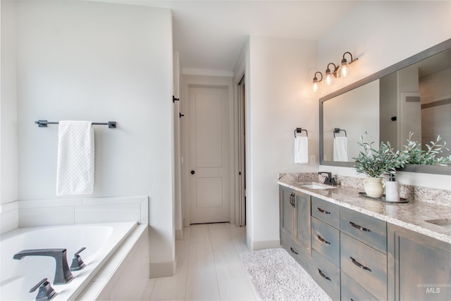 2649 E Mardia St, Meridian, ID 83642 - full bath with double vanity, a garden tub, baseboards, and tile patterned floors