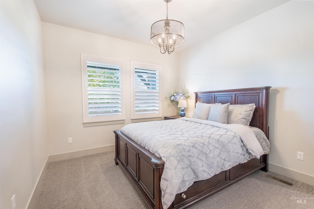 2649 E Mardia St, Meridian, ID 83642 - bedroom featuring a chandelier, baseboards, and light carpet