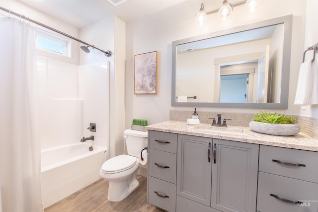 2649 E Mardia St, Meridian, ID 83642 - bathroom featuring vanity, wood finished floors, toilet, and shower / tub combo