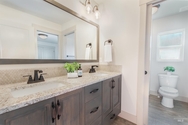 2649 E Mardia St, Meridian, ID 83642 - bathroom with double vanity, wood finished floors, toilet, and baseboards