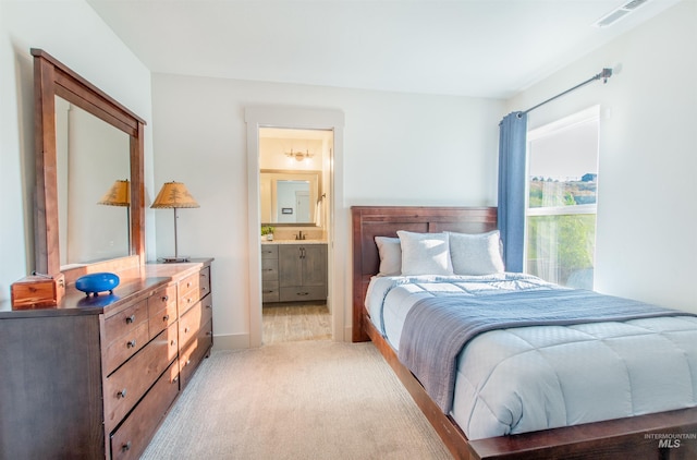2649 E Mardia St, Meridian, ID 83642 - bedroom featuring light carpet, connected bathroom, and baseboards