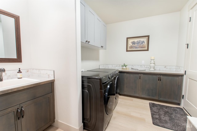 2649 E Mardia St, Meridian, ID 83642 - laundry room with independent washer and dryer, cabinet space, and light wood-style floors