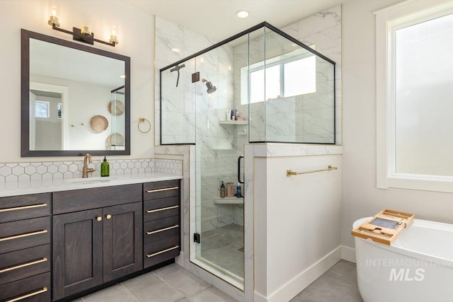 bathroom with tasteful backsplash, recessed lighting, a freestanding bath, a stall shower, and vanity