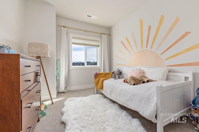 carpeted bedroom with baseboards and visible vents