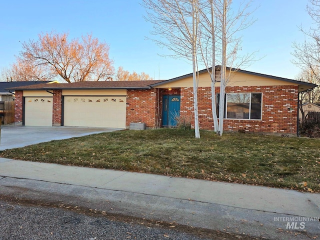 single story home featuring a garage and a front yard