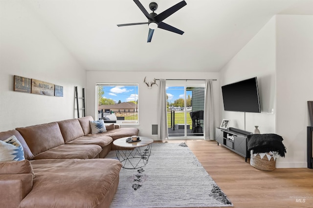 living room featuring light wood-type flooring, high vaulted ceiling, and ceiling fan