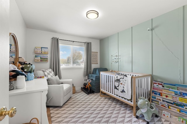 bedroom with light floors and a crib