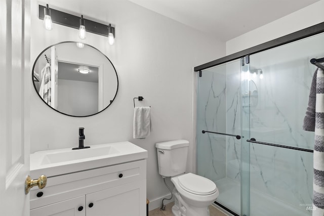full bathroom with a marble finish shower, vanity, and toilet