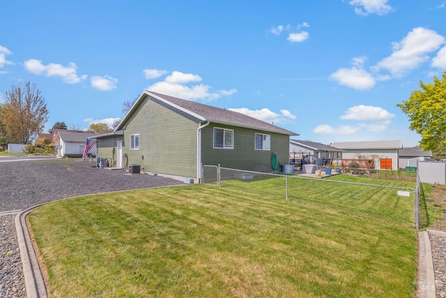 view of home's exterior featuring fence and a yard