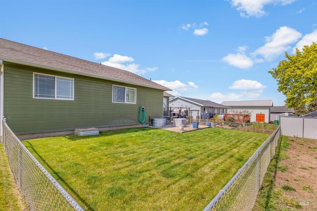 rear view of house featuring a patio area, a lawn, and a fenced backyard